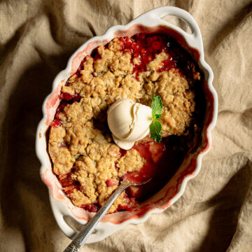 Spoon in a strawberry rhubarb crisp
