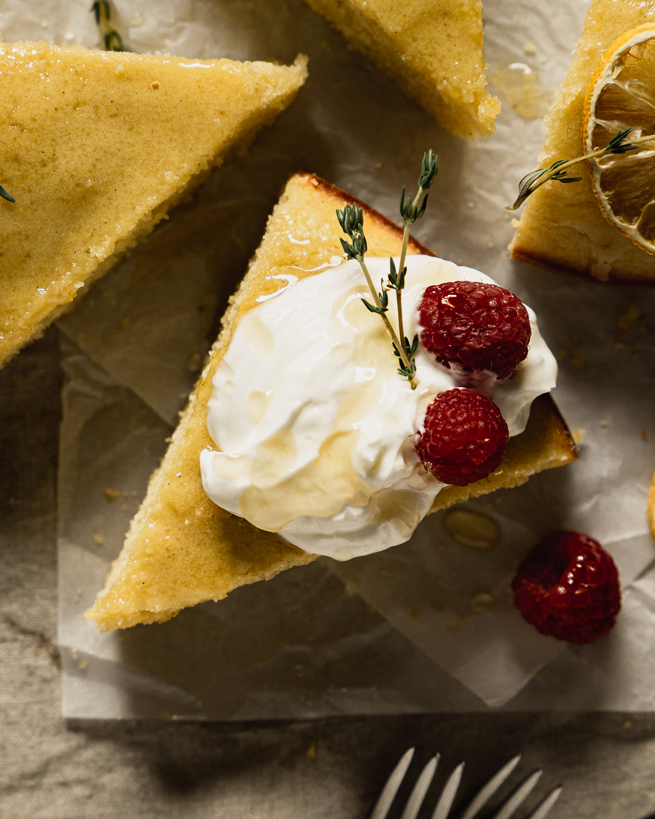 A slice of lemon cake with greek yogurt and raspberries