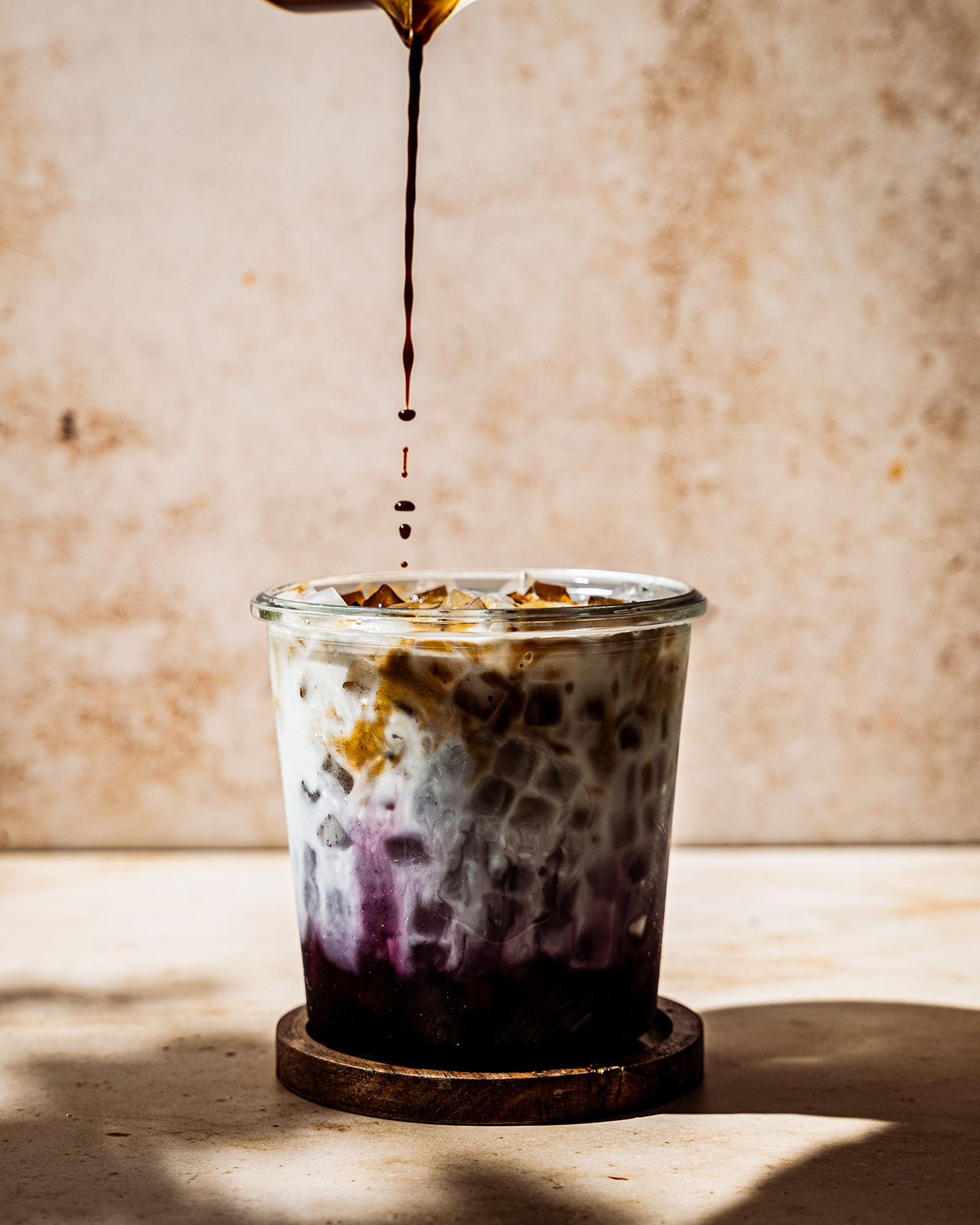 Espresso being poured into an iced latte