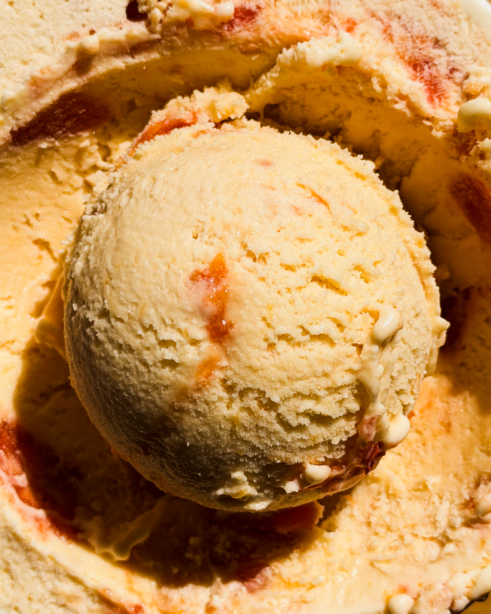 Homemade peaches and cream ice cream with roasted peach ripple