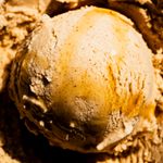 Scoop of maple chai ice cream with maple syrup on top