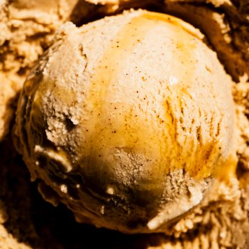 Scoop of maple chai ice cream with maple syrup on top